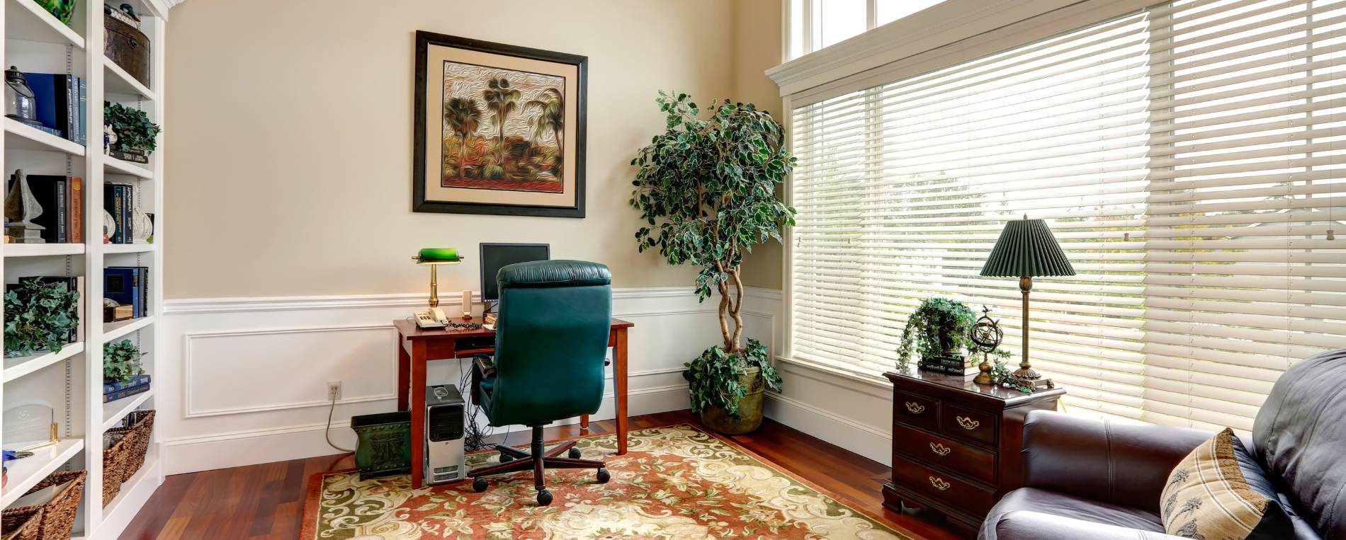 A view at a home office with a white vinyl window blinds